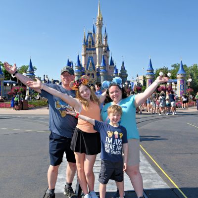 Fun family photo in front on Cinderella Castle at Magic Kingdom.